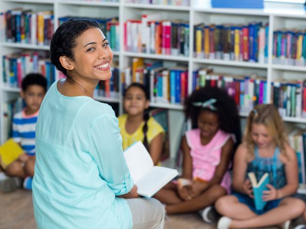 Teacher smiling with students in class