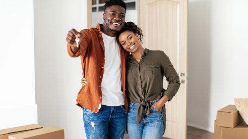 African American Millennial Couple Showing Key Posing In New House